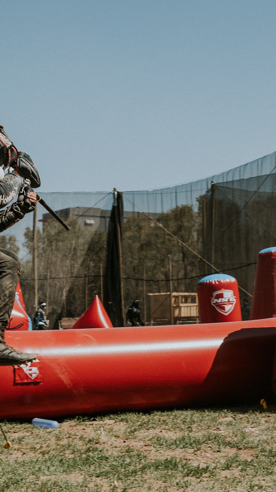 Player jumping over an inflatable bunker mid-match