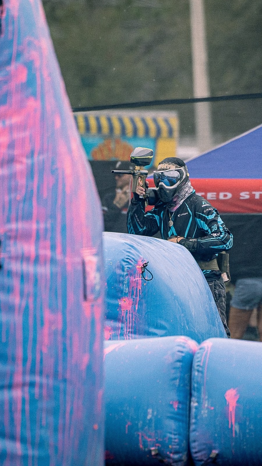 Player aiming through the bunkers with the USXBL tent behind